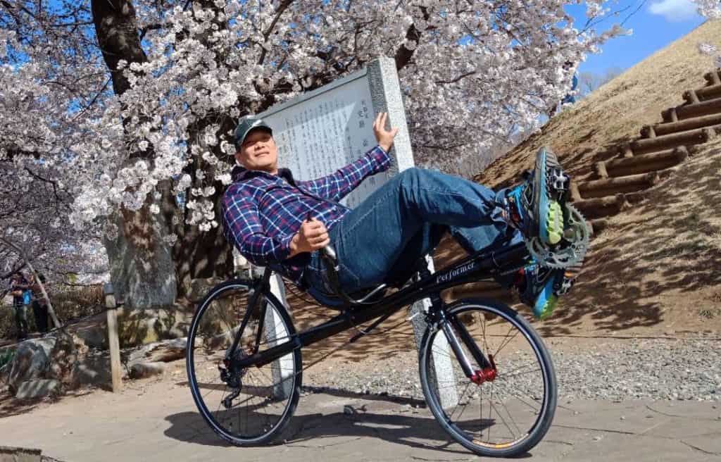 recumbent bike rider with cherry blossoms